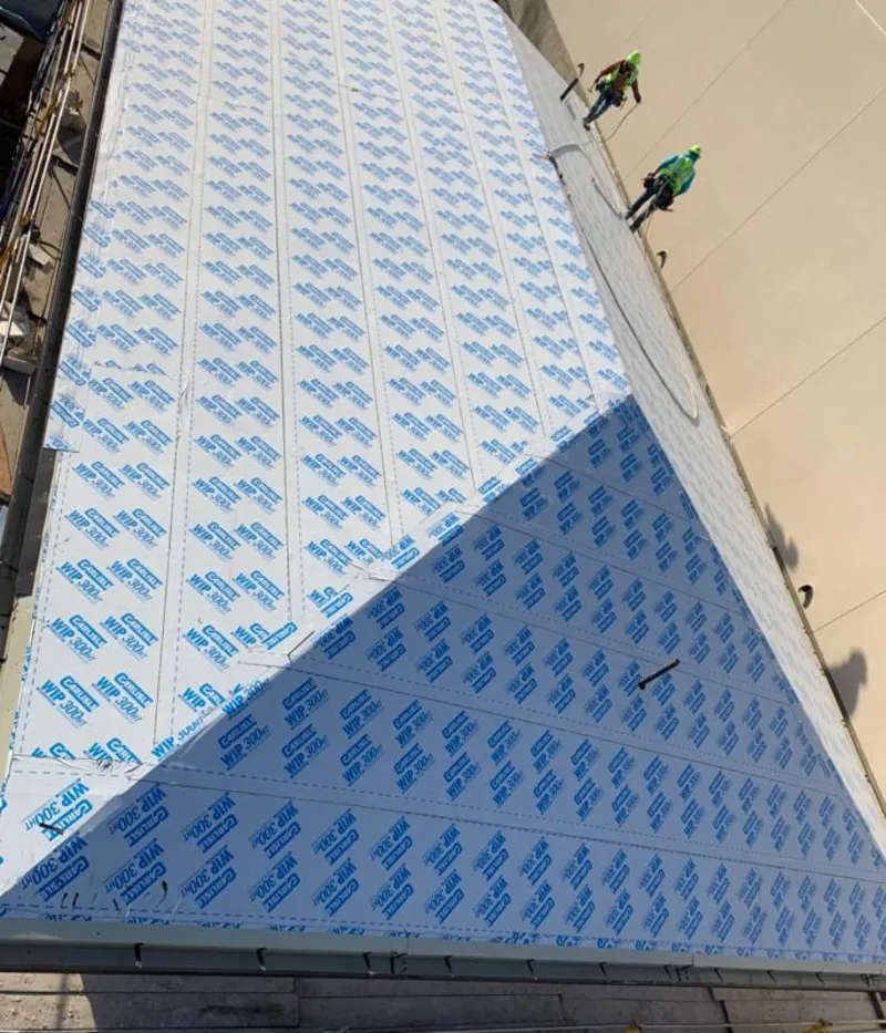 Professional roofers installing underlayment on a metal roof in Vandalia